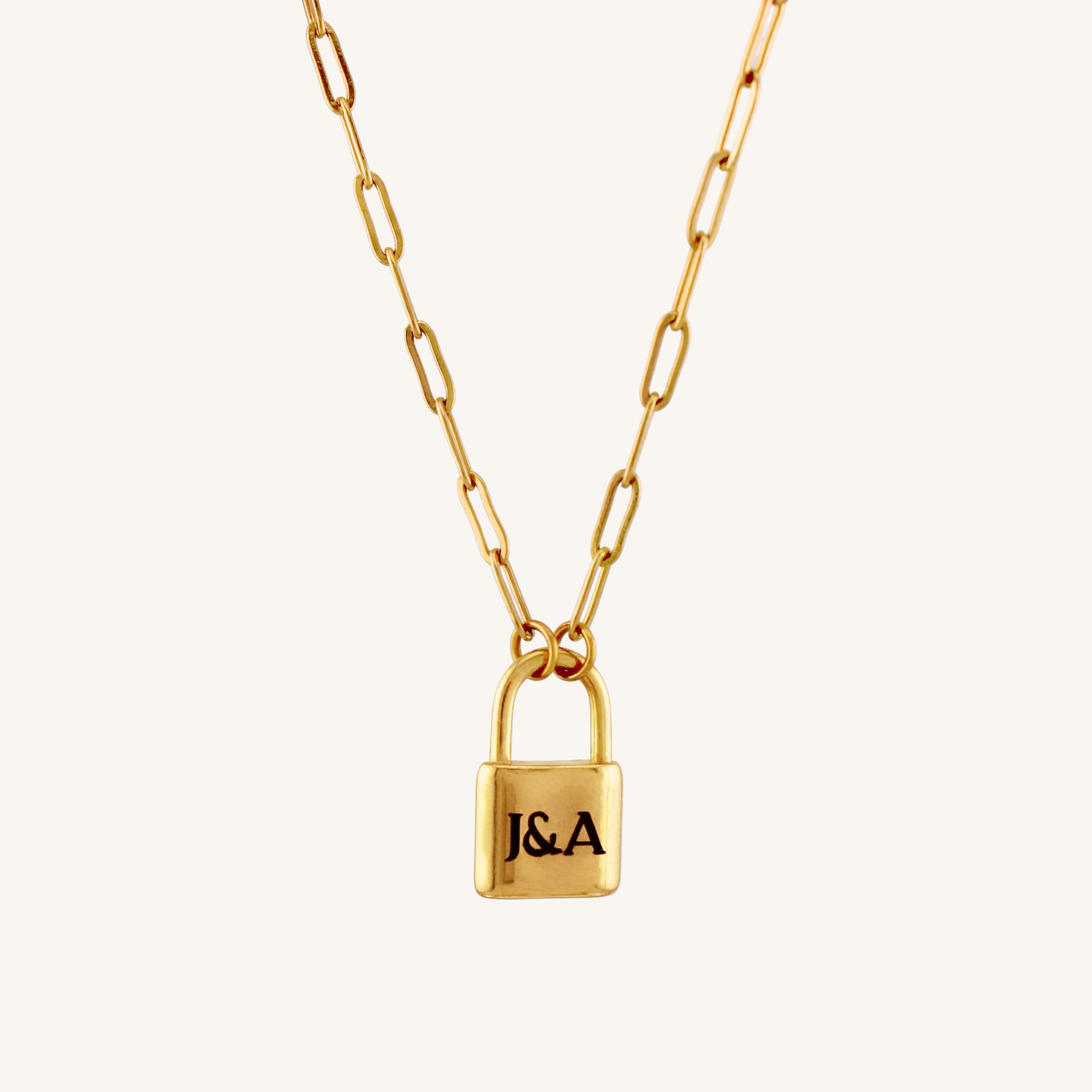 Gold necklace with a lock-shaped pendant on a white background