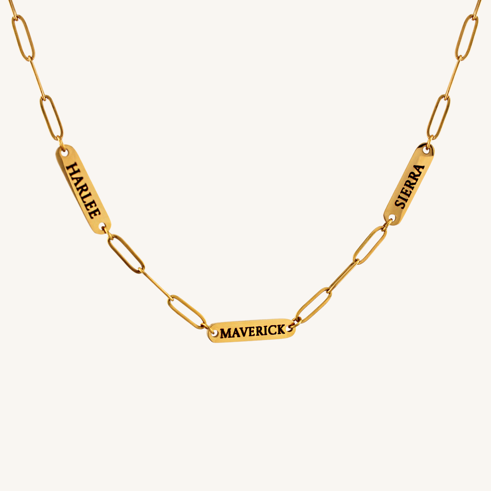 Gold chain necklace with engraved names on a white background