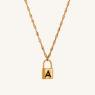 Gold necklace with a lock-shaped pendant featuring the letter 'A' on a white background