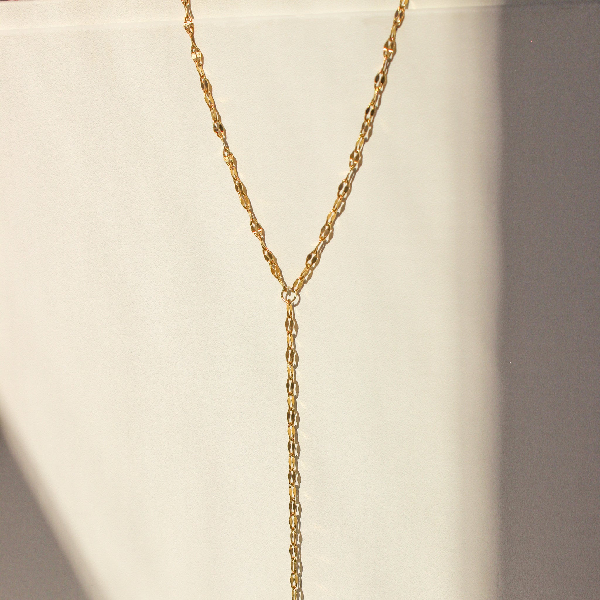 Gold chain necklace on a white background