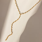 Gold necklace on a beige background