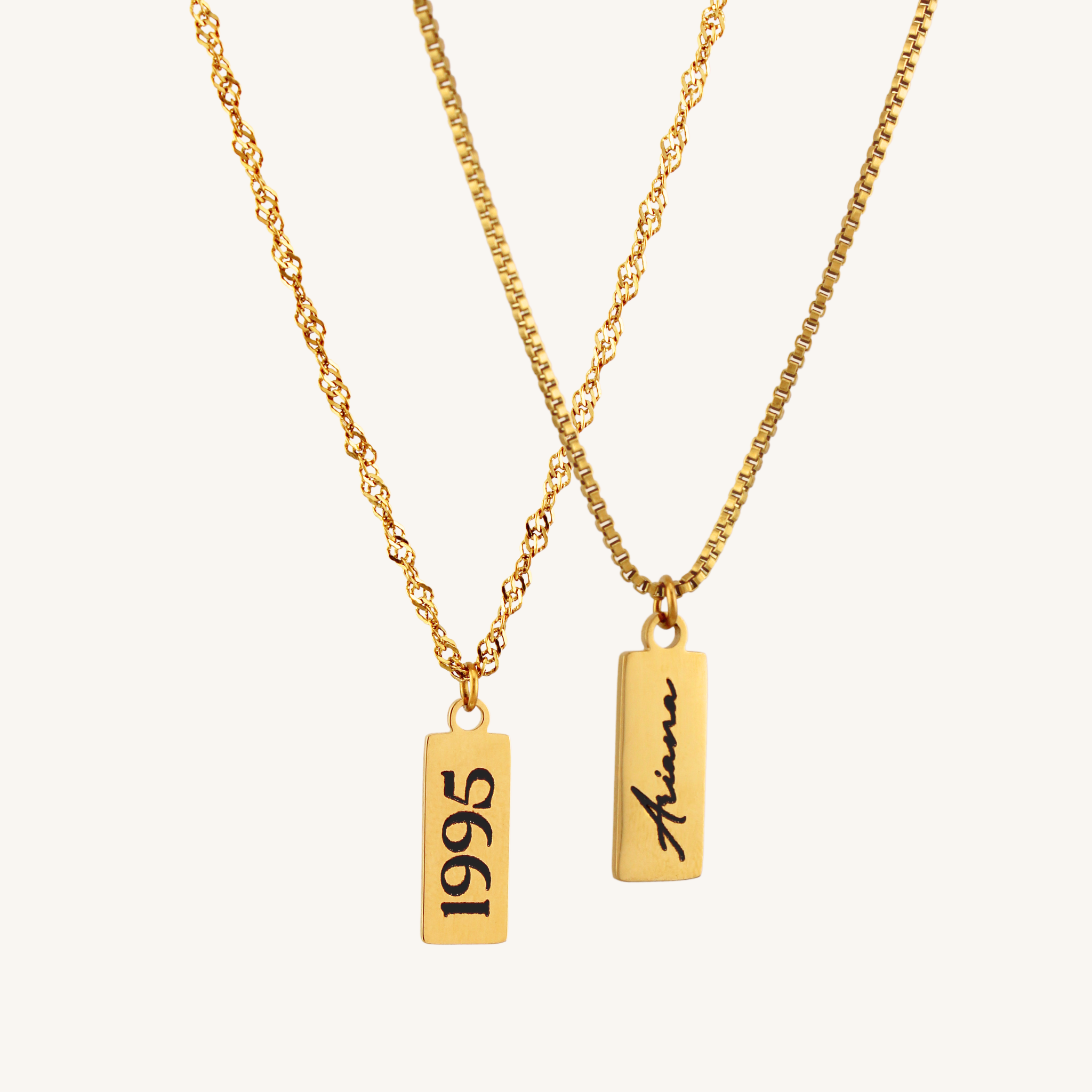 Two gold necklaces with pendant tags displaying '1995' and 'Ariana' on a white background.
